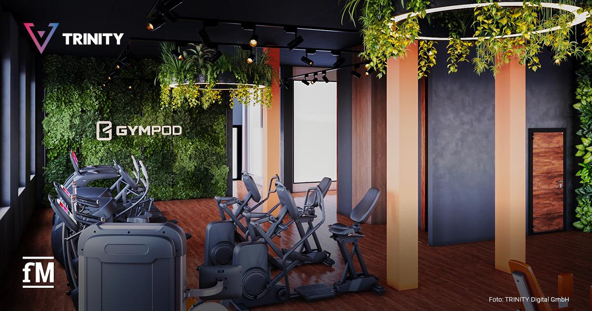 Modernes GYMPOD-Fitnessstudio mit stylischem Interior: Cardio-Geräte vor einer begrünten Wand, hängende Pflanzen von der Decke, warme Holzböden und stilvolle Lichtakzente.