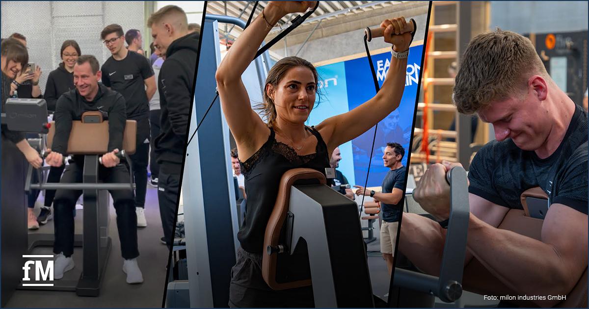 Trainer demonstrieren eine Kraftübung an Trainingsgeräten von milon während der milon & five Trainer Convention 'Mobilität' in einem modern ausgestatteten Studio.