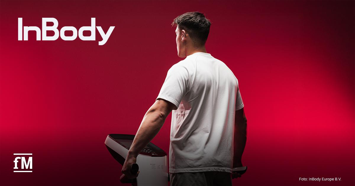 Ein sportlich gebauter Mann steht in weißem Shirt auf einem InBody-Messgerät und blickt in einen kräftig roten Hintergrund. Links oben das InBody-Logo, unten links das fM-Logo.