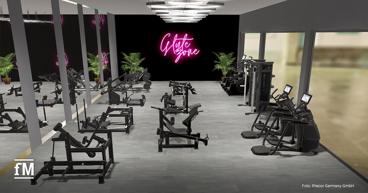Trainingsfläche mit mehreren Precor Glutebuilder-Geräten und neonpinkem Schriftzug 'Glute Zone'.