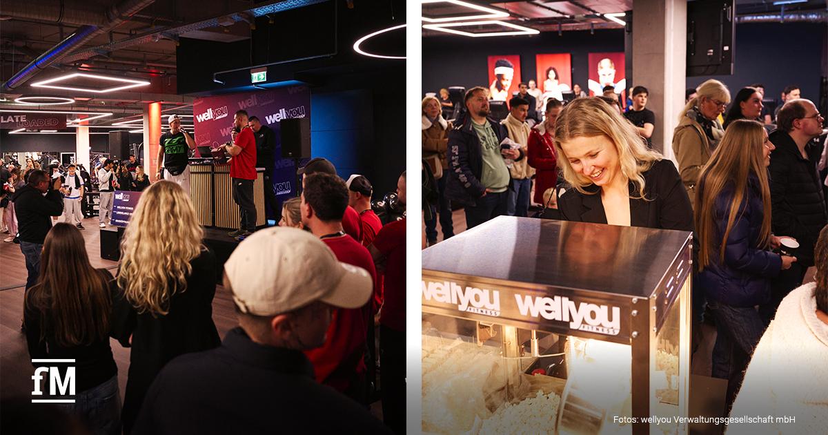 Zahlreiche Menschen im neuen wellyou Fitnessstudio Velbert, im Vordergrund eine Frau an einer Popcornmaschine.