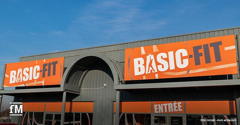 Basic-Fit Außenansicht eines Basic-Fit-Studios mit großen orangefarbenen Basic-Fit-Schildern