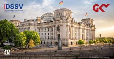 Ansicht des Reichstagsgebäudes in Berlin bei warmem Abendlicht, mit Glaskuppel, mehreren Deutschlandflaggen und Logos von DSSV und GKV im Bild.